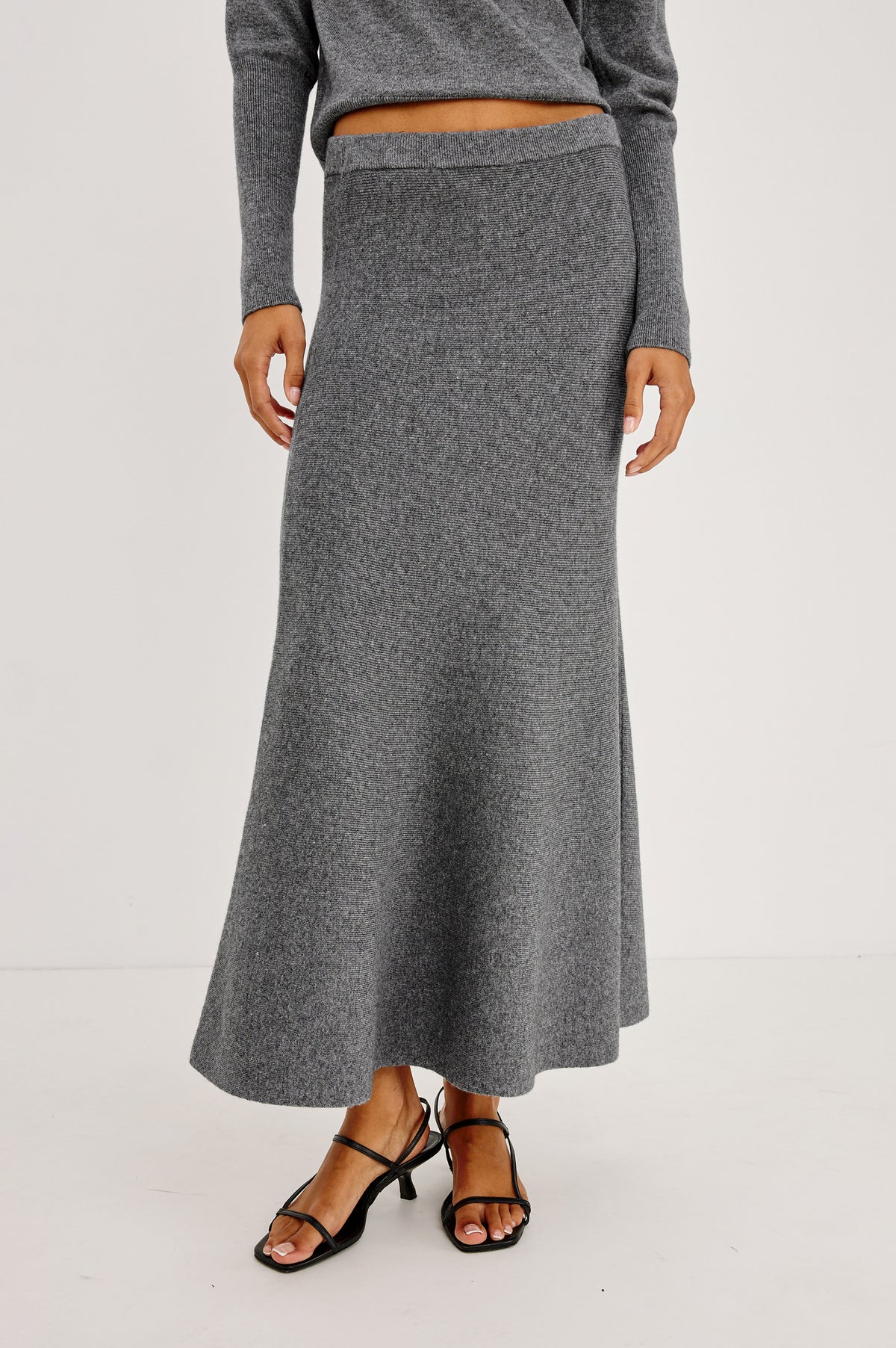Odita Maxi Skirt in Soft Ribbed Wool Blend Knit With Elastic Waist, and A-Line Silhoeutte in Heather Charcoal Colorway - Crop Front View Featured on Model.