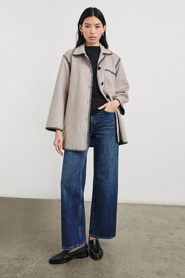 Odyssey Jacket with Four Button Closure and a Chest Patch Pocket in Oatmeal Colorway, with black contrast stitching - Front Full Body View Featured on Model