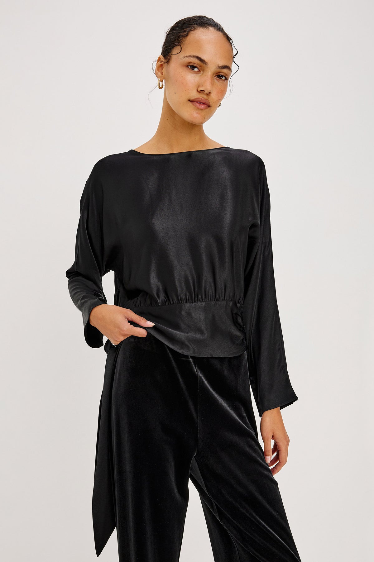 Opal Long-Sleeve Top in Luxe Satin With a Self Tie Hem in Black Colorway - Front Crop View Featured on Model.