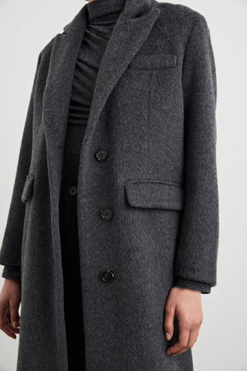 Opera Below-the-Knee Length Coat with V Neck, Three-Button Closure and Two Front Flap Patch Pockets in Charcoal Colorway - Front View Featured on Model