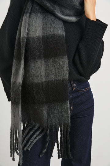 Oslo Scarf with Twisted Tassels and a Checkered Pattern in Charcoal Black Colorway - Front View Featured on Model