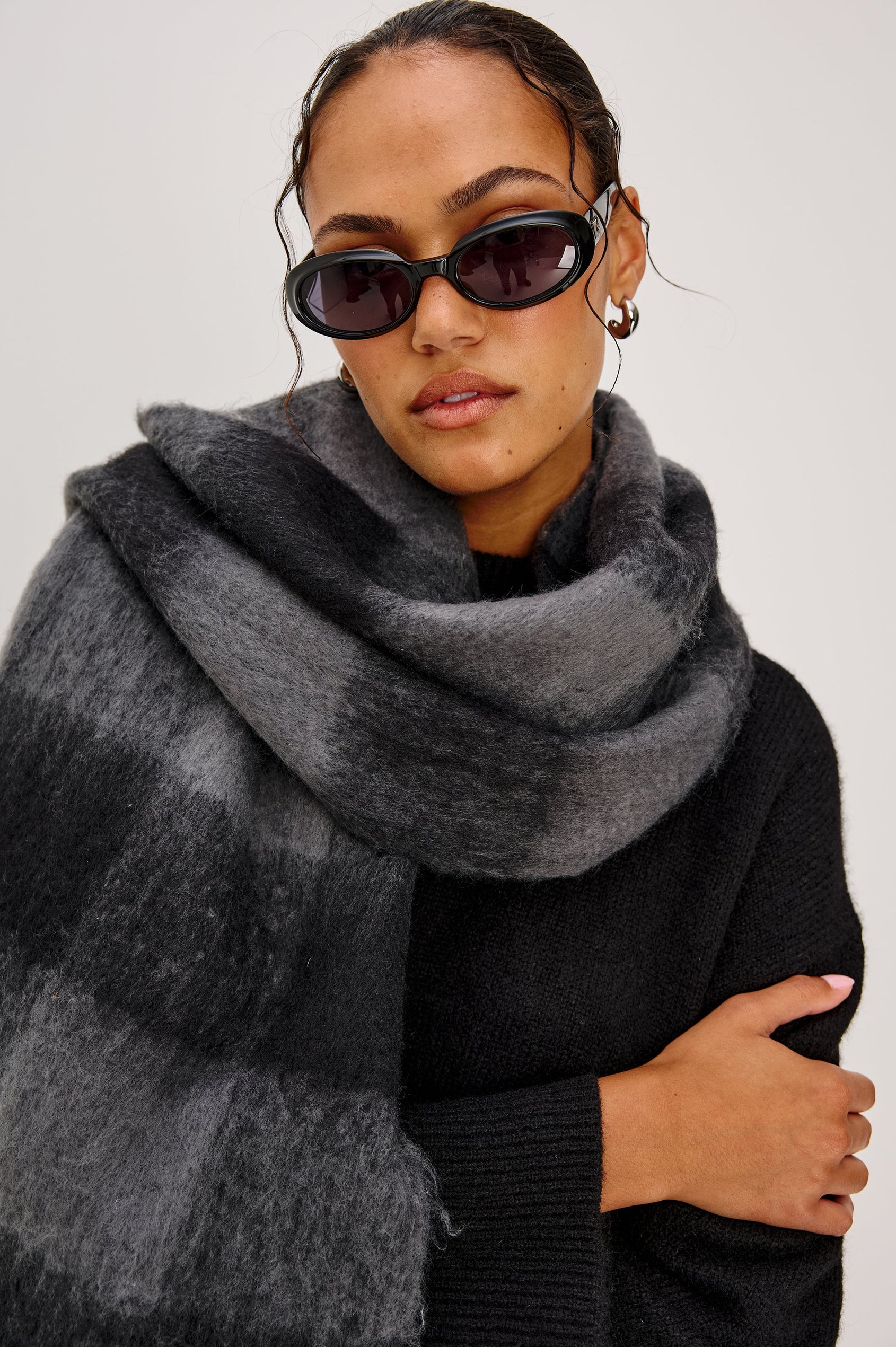 Oslo Scarf with Twisted Tassels and a Checkered Pattern in Charcoal Black Colorway - Front Detail View Featured on Model