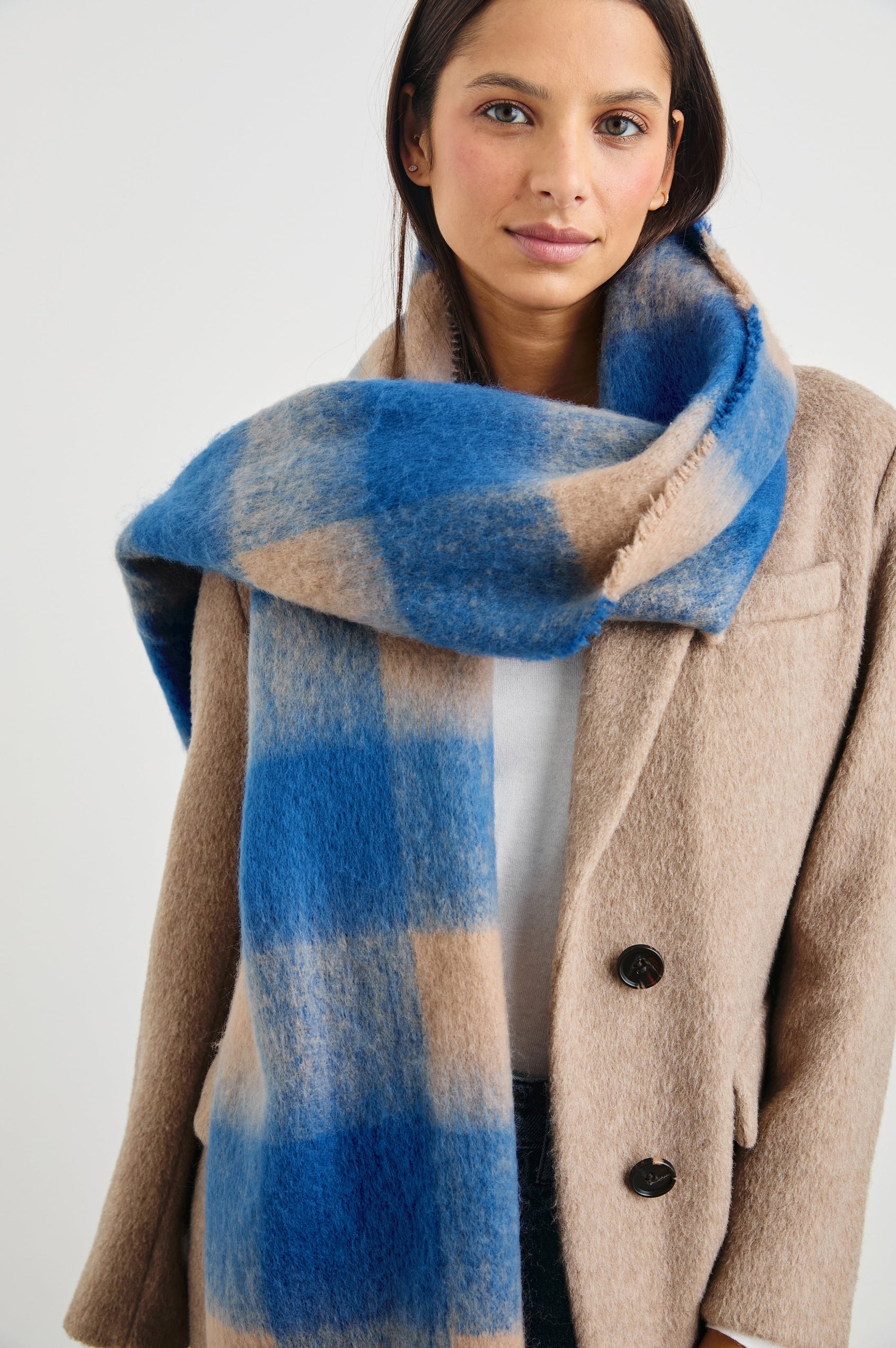 Oslo Scarf with Twisted Tassels and a Checkered Pattern in Cobalt Camel Colorway - Front View Featured on Model