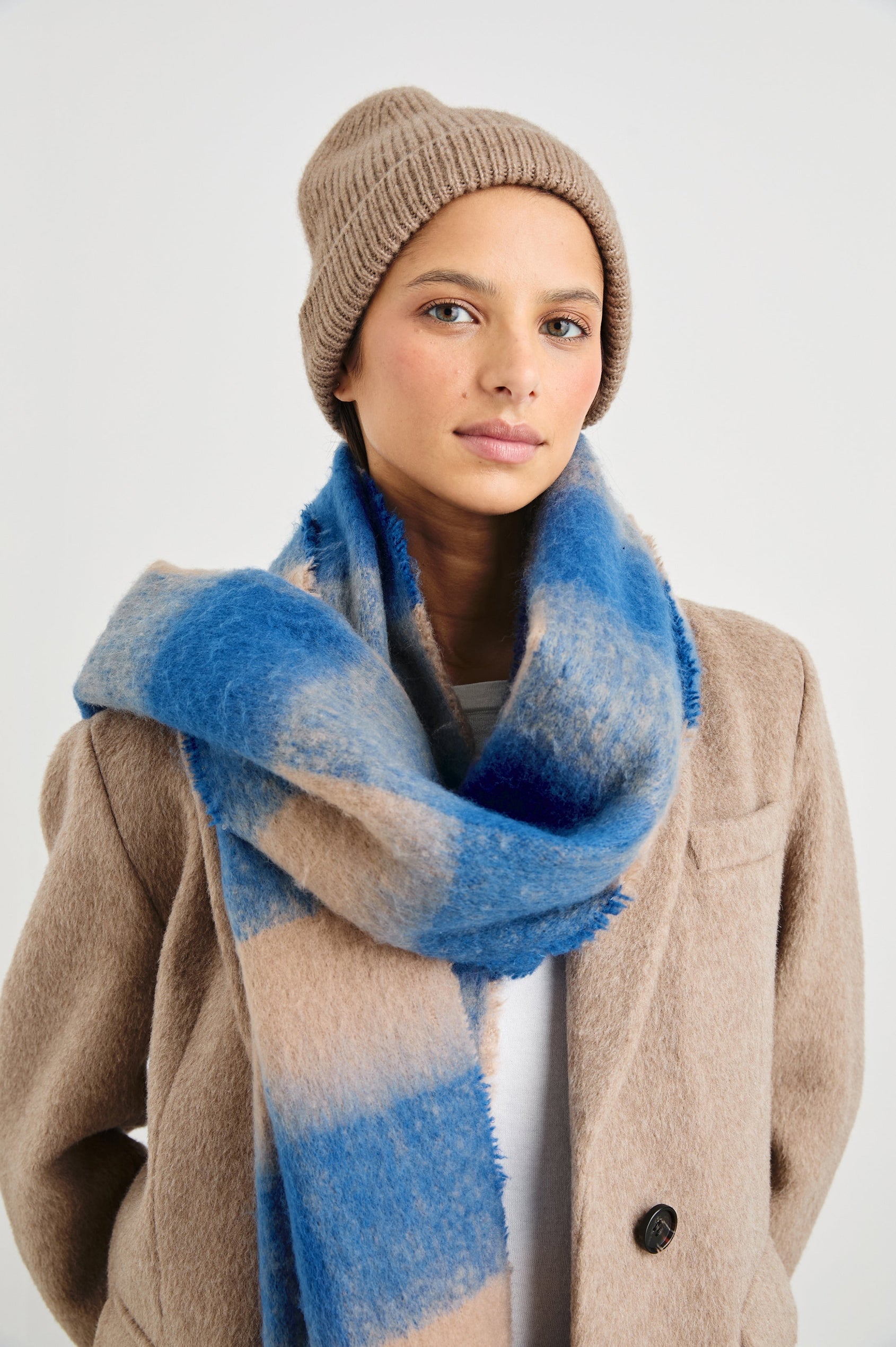 Oslo Scarf with Twisted Tassels and a Checkered Pattern in Cobalt Camel Colorway - Front View Featured on Model