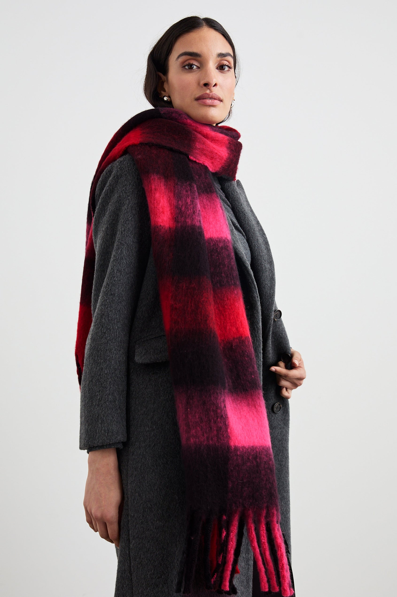 Oslo Scarf with Twisted Tassels and a Checkered Pattern in Scarlet Onyx Pink Colorway - Front View Featured on Model