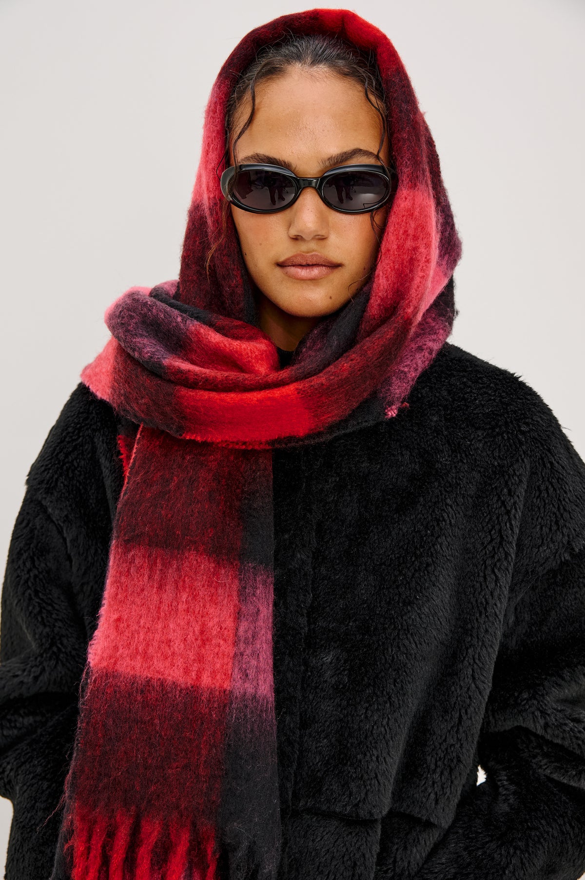 Oslo Scarf with Twisted Tassels and a Checkered Pattern in Charcoal Black Colorway - Front View Featured on Model