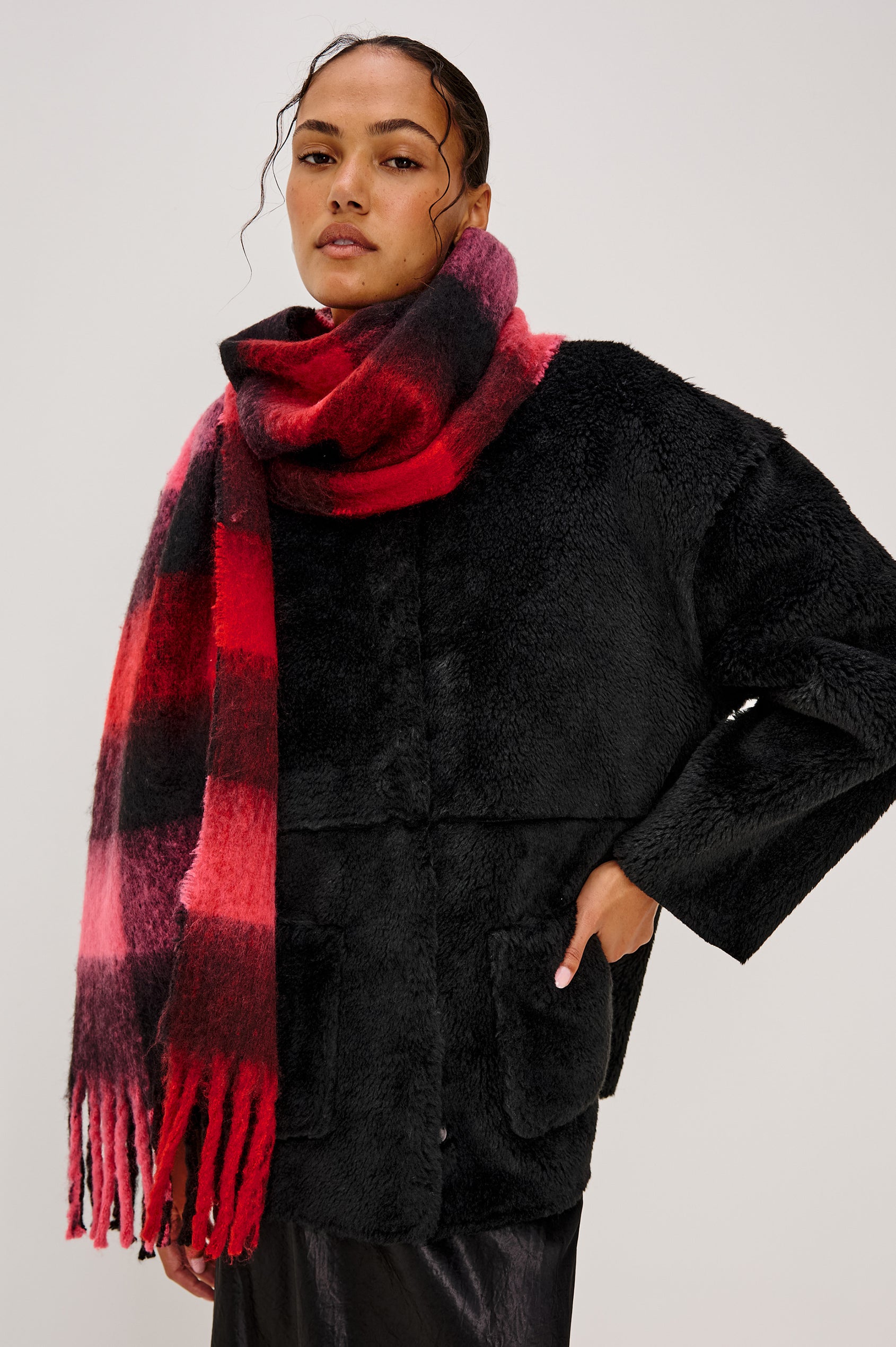 Oslo Scarf with Twisted Tassels and a Checkered Pattern in Charcoal Black Colorway - Front View Featured on Model