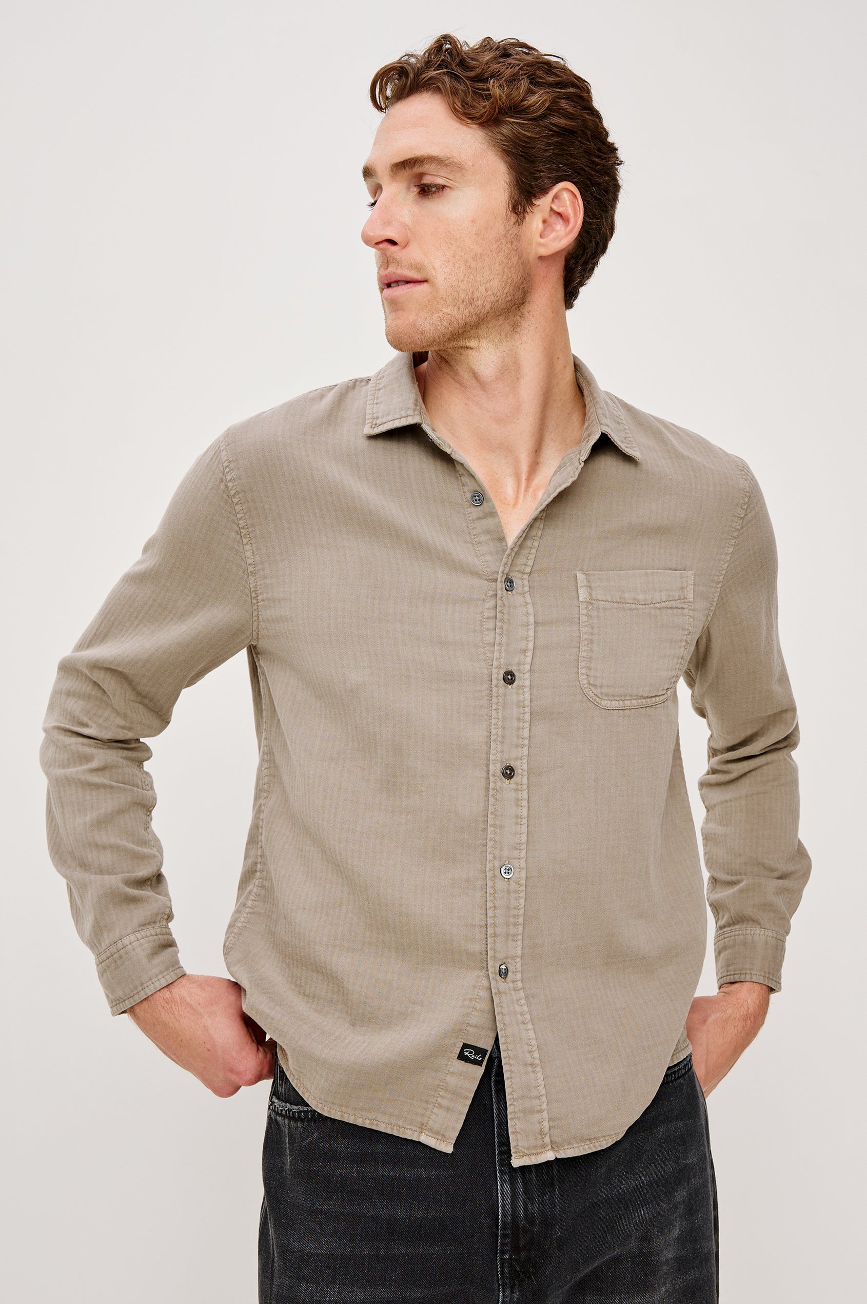Owens is a long sleeve, collared, button front shirt lightweight cotton, long sleeve, and features a subtle pattern variation on the backside of the fabric in Desert Path colorway. Front view featured on model.