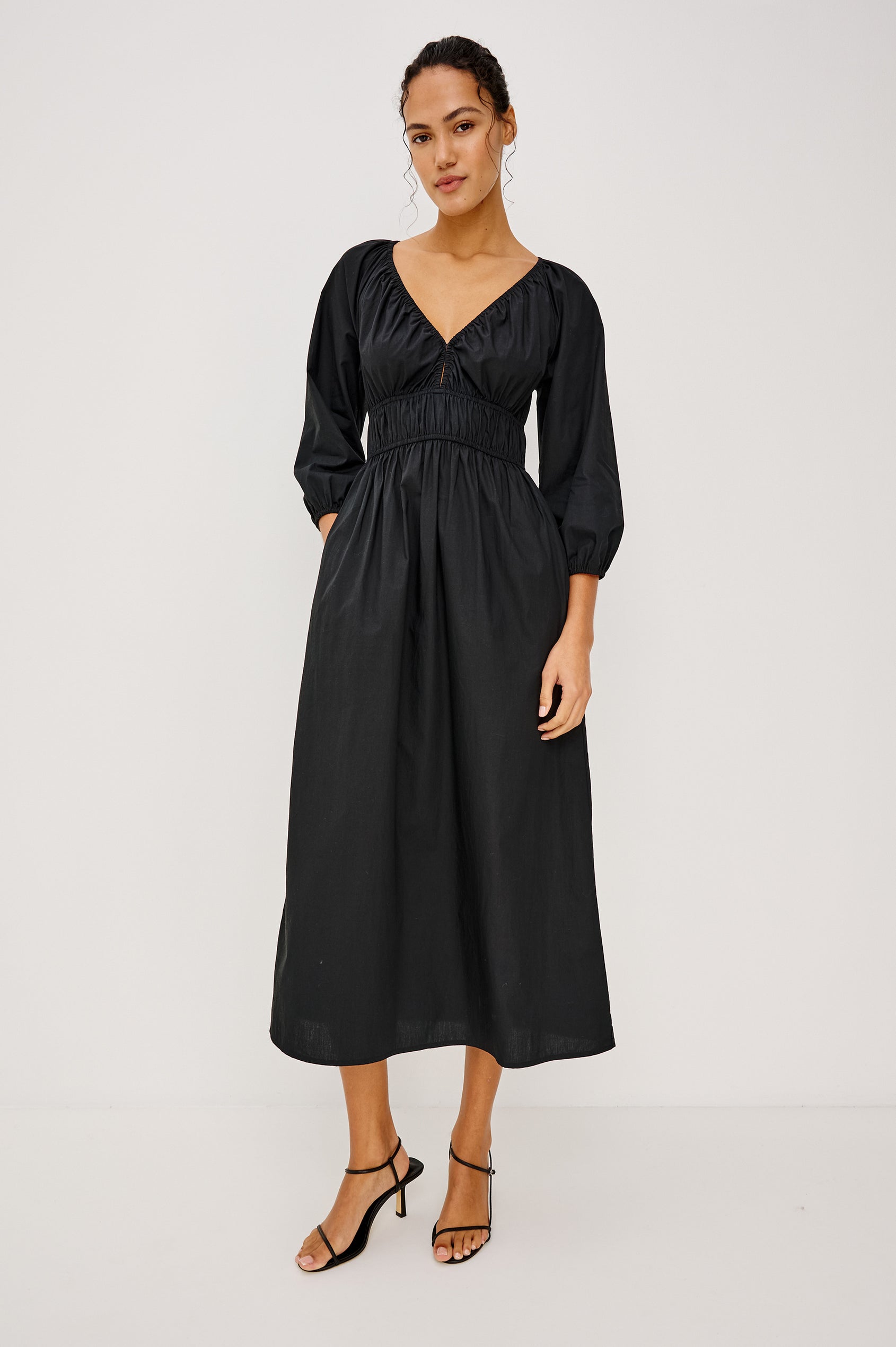 Paio Midi Dress in Crinkle Poplin With Elastic V-Neck, Waist, and Cuffs, Bust Keyhole Cut Out, and Three-Quarter Sleeves in Black Colorway - Full Body Front View Featured on Model