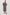 Paio midi dress with a fitted bodice, three quarter sleeves with a slight puff effect, flowing skirt, and eyelet closures at the chest in Painted Noir colorway - full body front view of model posing with hands behind back