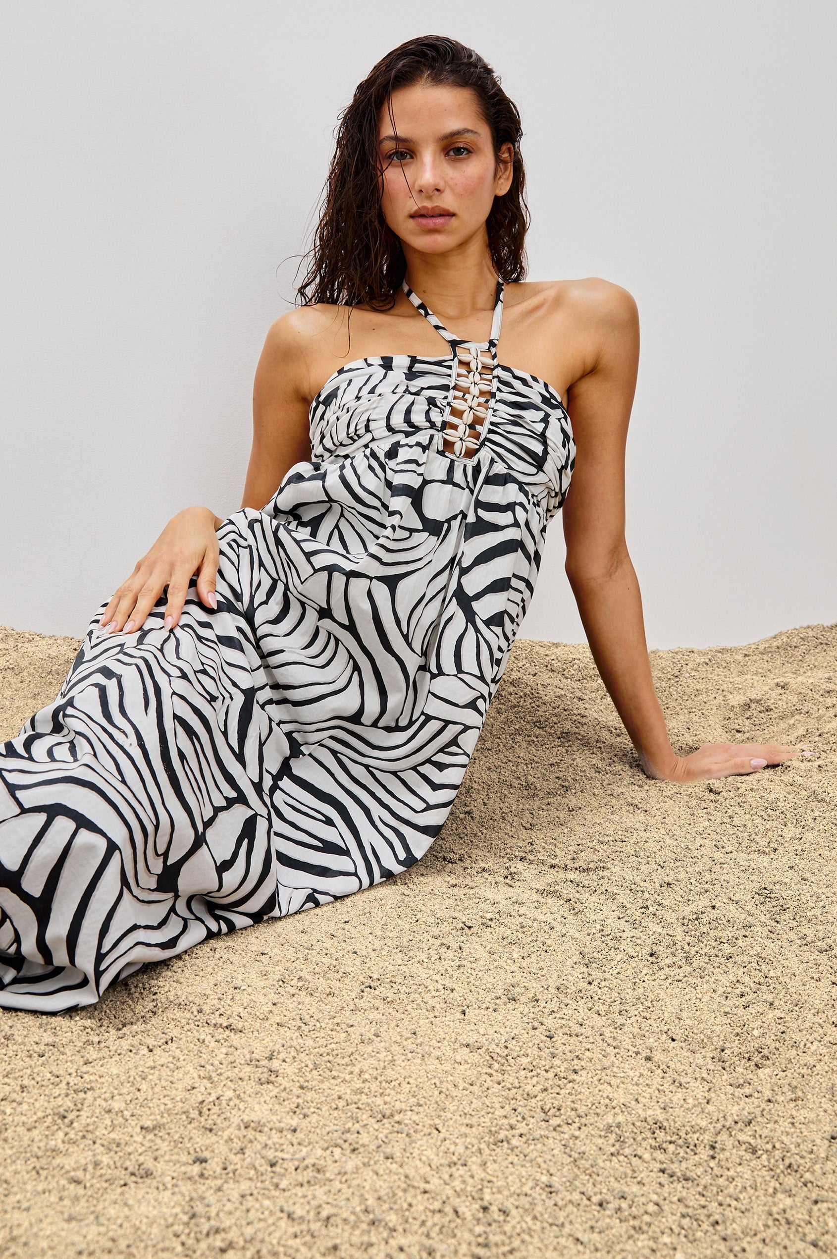 Palazzo Halter Midi Length Dress with Tie Neck and Sea Shell Lattice Detail at Center Front in White and Black Abstract Playa Blanco Colorway. Front View Shown on Model.