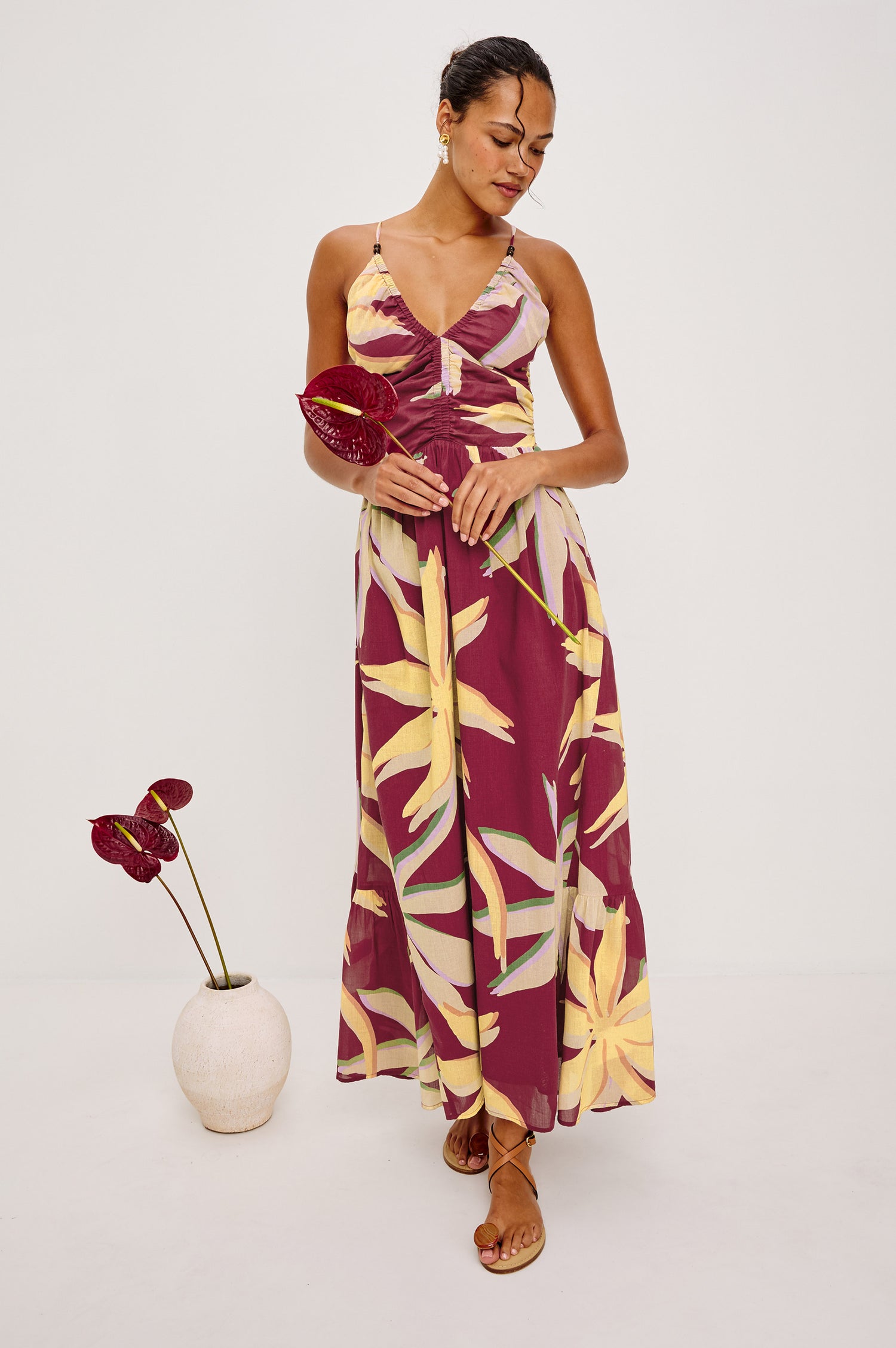 Palm Maxi Dress in Beach Cotton WIth Fitted Shirred Bodice V-Neckline Adjustable Shoulder Straps With Wooden Bead Detailing and Tiered Skirt in Red Palma Colorway - Full Body Front View Featured on Model