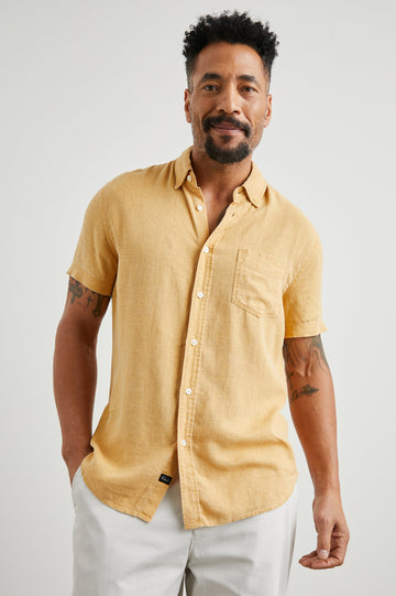 Paros Short-Sleeve Button Up with a Chest Patch Pocket in Uni Colorway, a Yellow - Front View Featured on Model