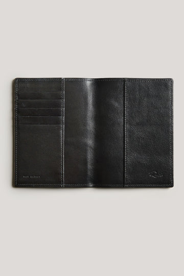 Leather passport holder opened, detailed inside view with, in Black colorway.