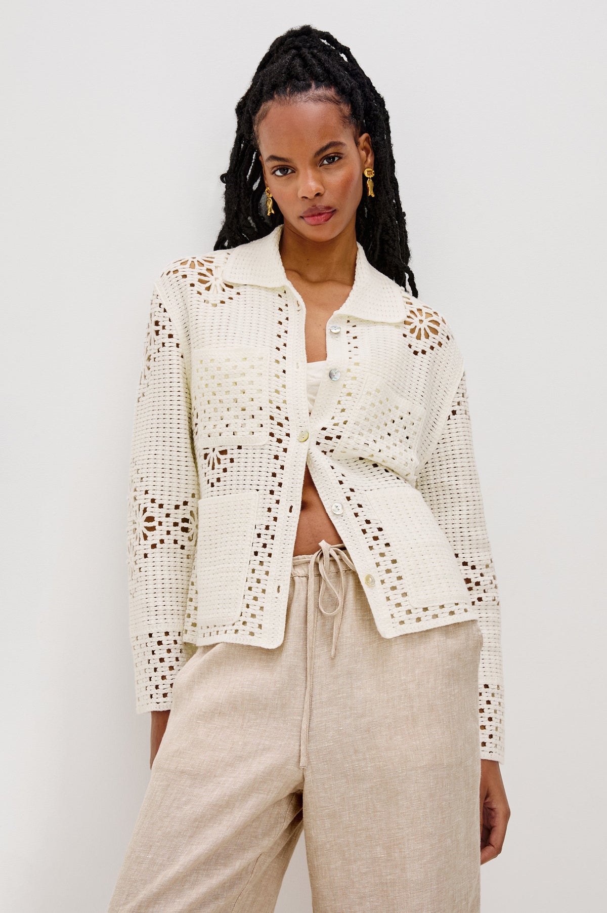Patmos Collared Button Front Sweater Cardigan with Long Sleeves and Four Front Patch Pockets in Ivory Colorway. Front View Shown on Model.