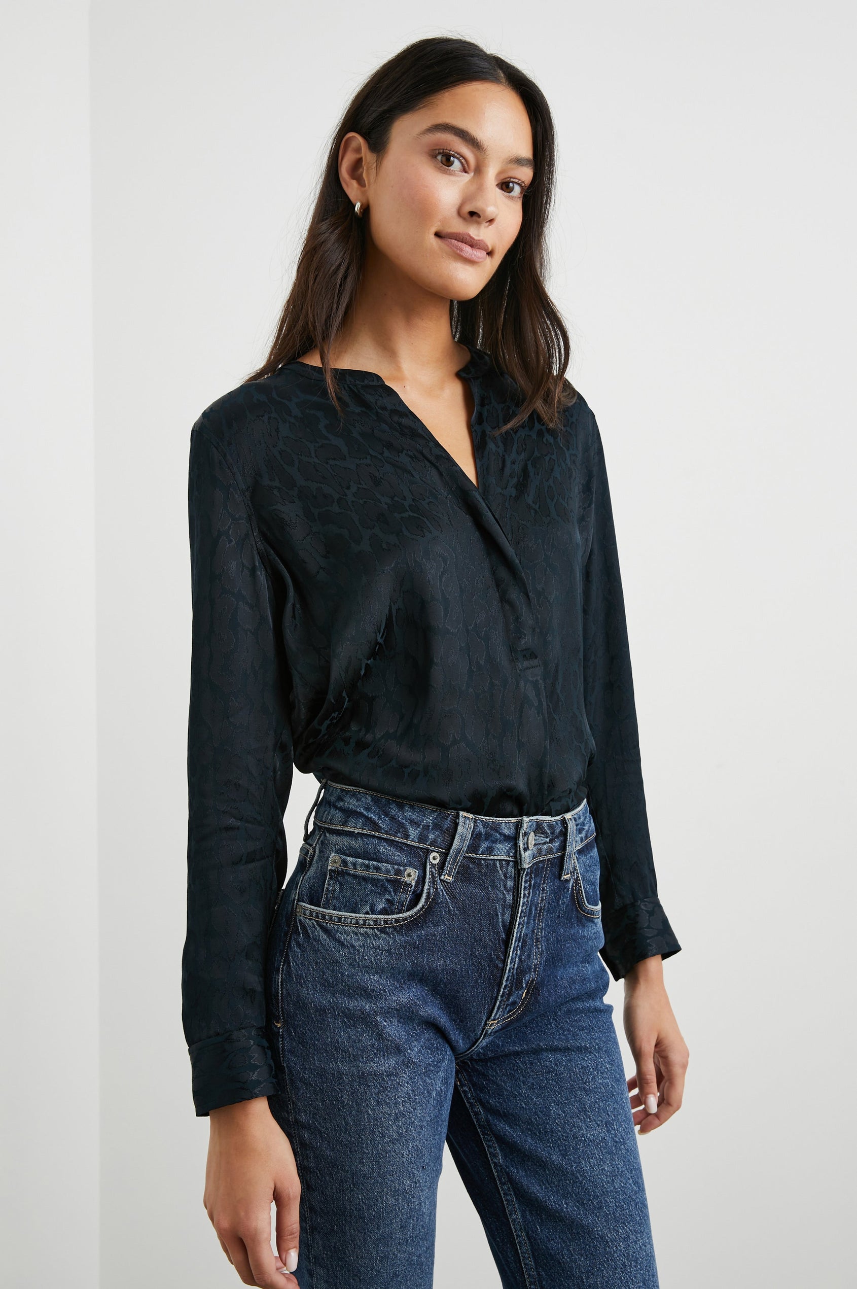 Pearl Long-Sleeve Top with a Half Sealed Placket, Button Cuffs and Side Slits in Onyx Leopard Colorway, Black Spots on Black - Front Tucked View Featured on Model 