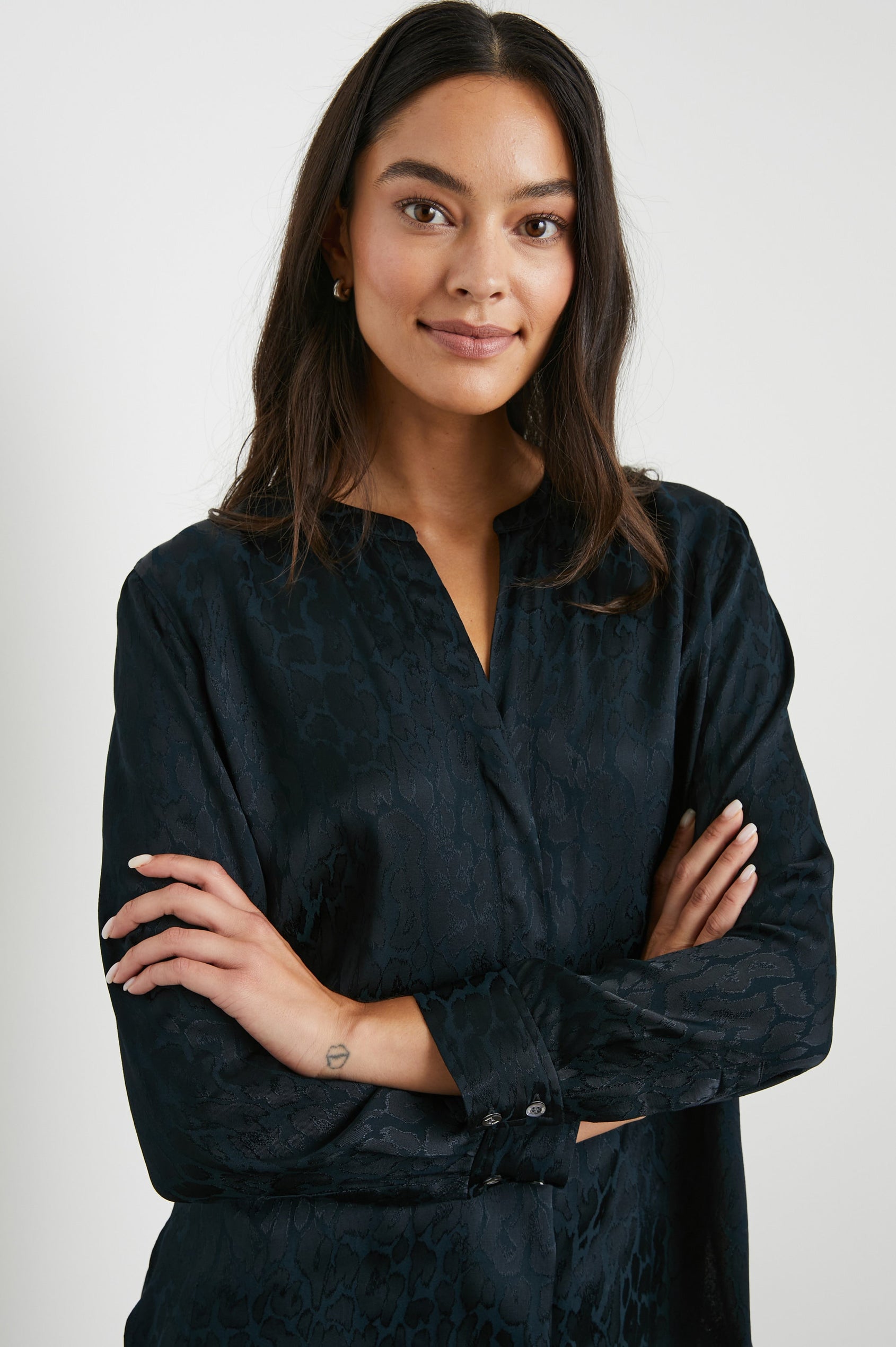 Pearl Long-Sleeve Top with a Half Sealed Placket, Button Cuffs and Side Slits in Onyx Leopard Colorway, Black Spots on Black - Front View Featured on Model 