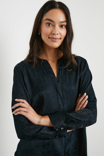 Pearl Long-Sleeve Top with a Half Sealed Placket, Button Cuffs and Side Slits in Onyx Leopard Colorway, Black Spots on Black - Front View Featured on Model 