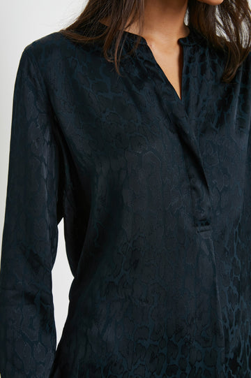 Pearl Long-Sleeve Top with a Half Sealed Placket, Button Cuffs and Side Slits in Onyx Leopard Colorway, Black Spots on Black - Front View Featured on Model 