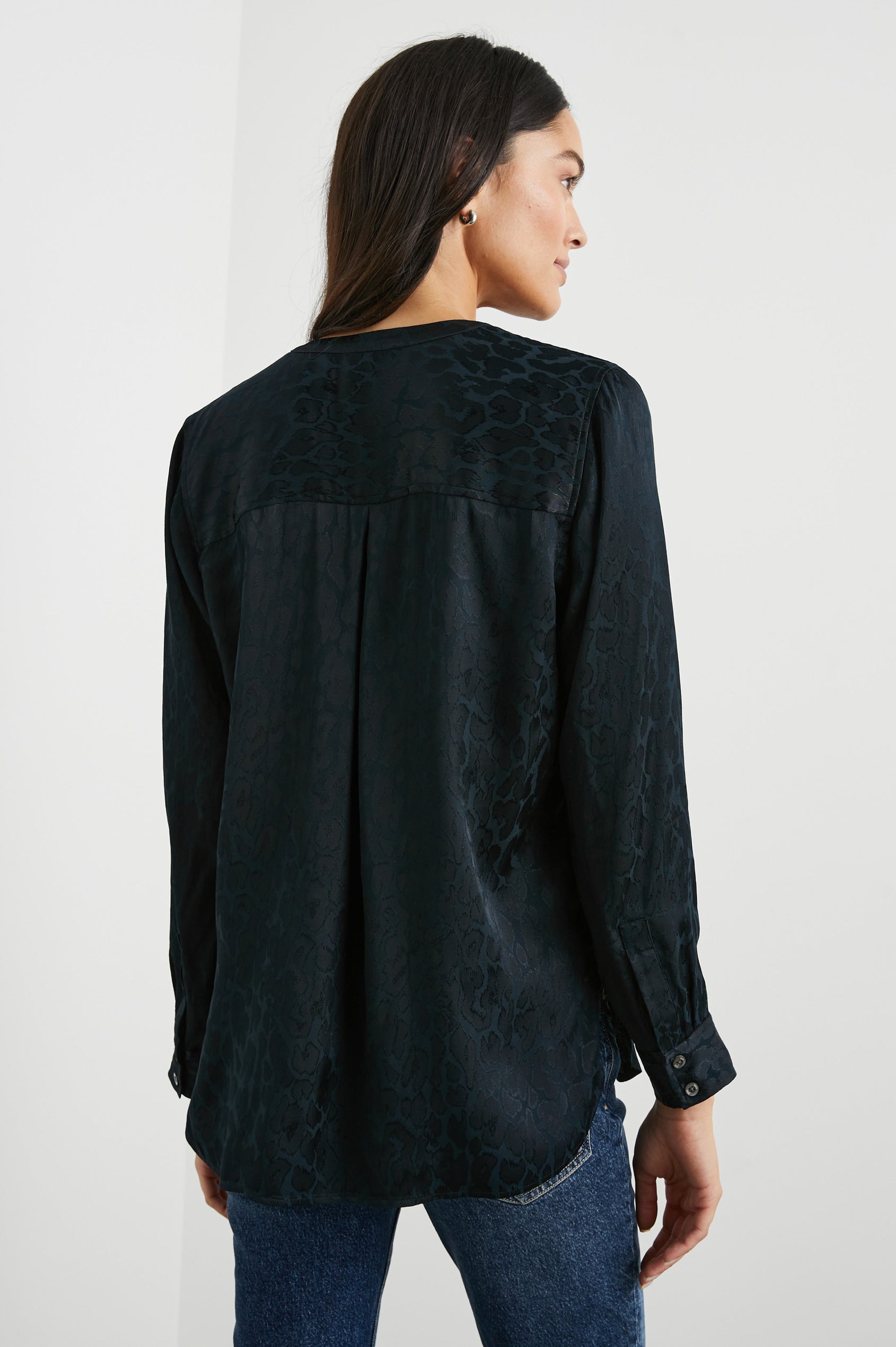 Pearl Long-Sleeve Top with a Half Sealed Placket, Button Cuffs and Side Slits in Onyx Leopard Colorway, Black Spots on Black - Back View Featured on Model 