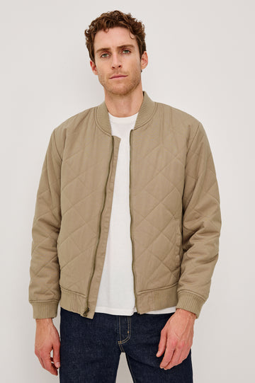 Peninsula Jacket with Zip Closure, Two Front Pockets, an Inner Zippered Pocket, a Quilted Pattern and Ribbed Trim in Vintage Khaki Colorway - Front View Featured on Model