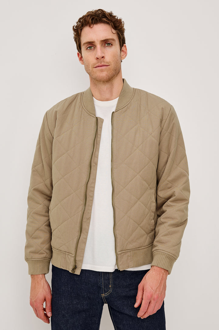 Peninsula Jacket with Zip Closure, Two Front Pockets, an Inner Zippered Pocket, a Quilted Pattern and Ribbed Trim in Vintage Khaki Colorway - Front View Featured on Model