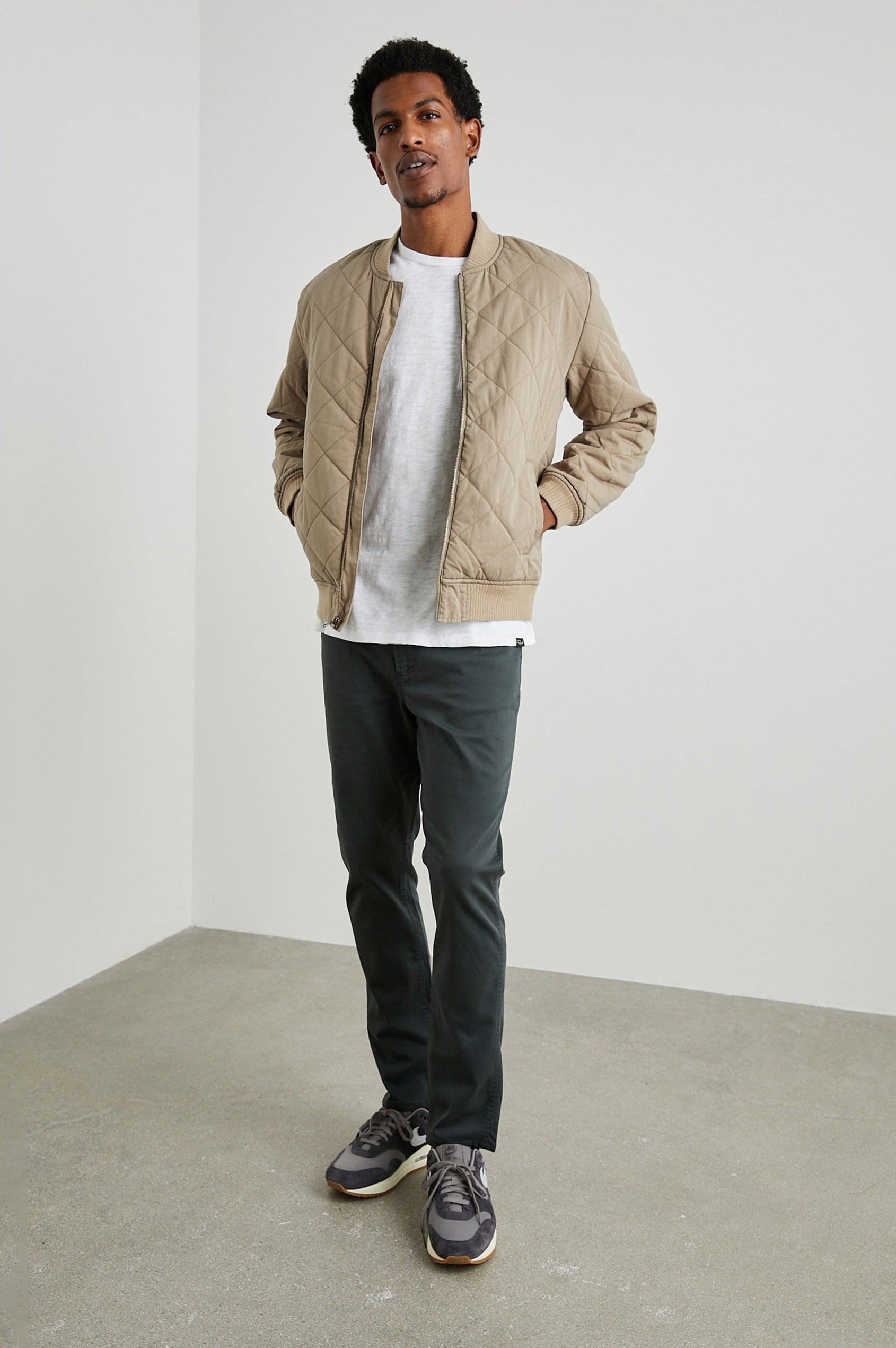 Peninsula Jacket with Zip Closure, Two Front Pockets, an Inner Zippered Pocket, a Quilted Pattern and Ribbed Trim in Vintage Khaki Colorway - Front Full Body View Featured on Model