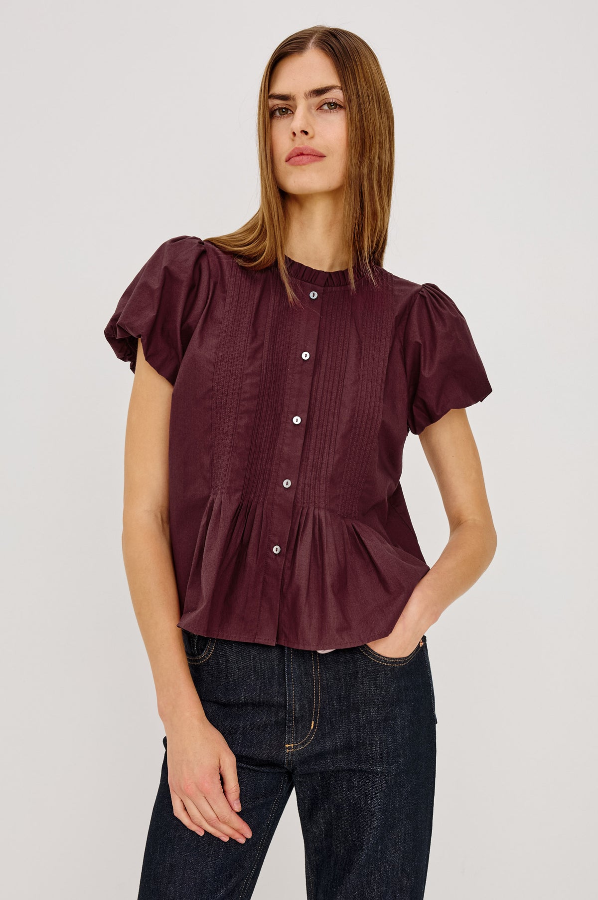 Pepper Shirt in Cotton Poplin With Loose Boxy Fit, Pintuck Detailing, Puff Cap Sleeves, Center-Front Buttons, and Soft Peplum Hem in Port Colorway - Upper Body Front View Featured on Model