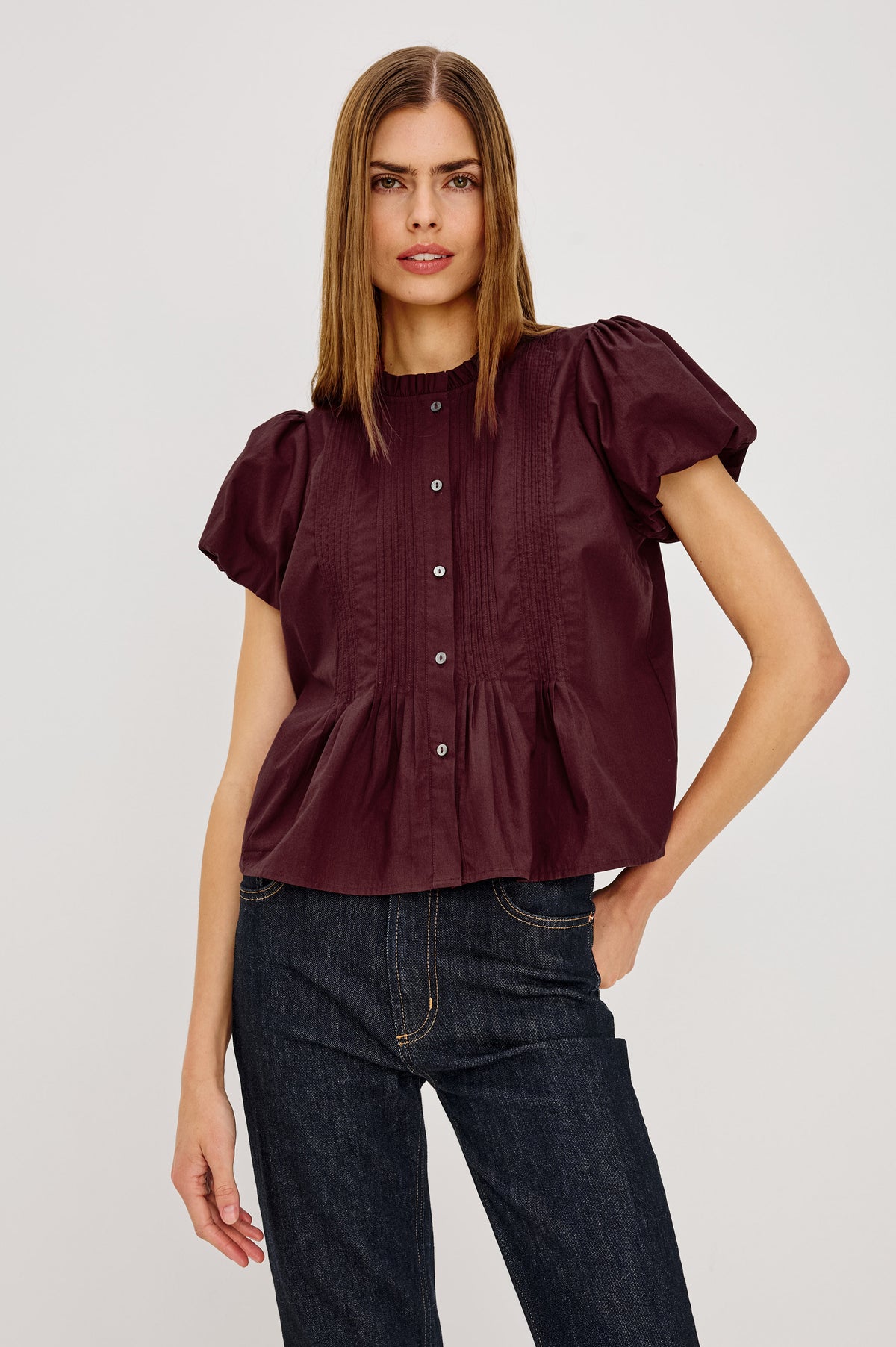 Pepper Shirt in Cotton Poplin With Loose Boxy Fit, Pintuck Detailing, Puff Cap Sleeves, Center-Front Buttons, and Soft Peplum Hem in Port Colorway - Upper Body Front View Featured on Model