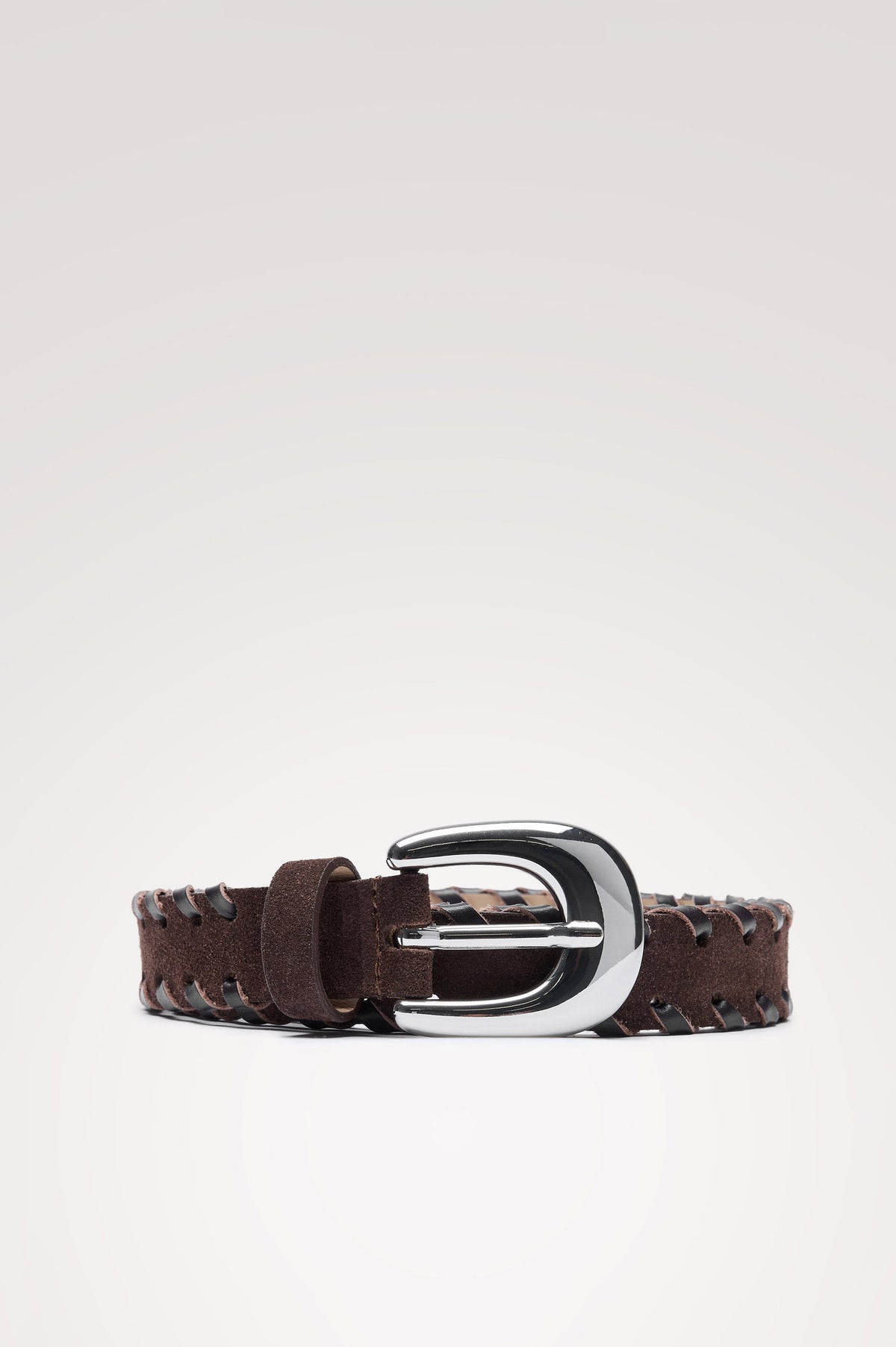 Phoenix Belt is crafted from soft suede with braided trim along the edges, finished with a rounded buckle in Dark Brown Silver Colorway - Front View Featured on Model.