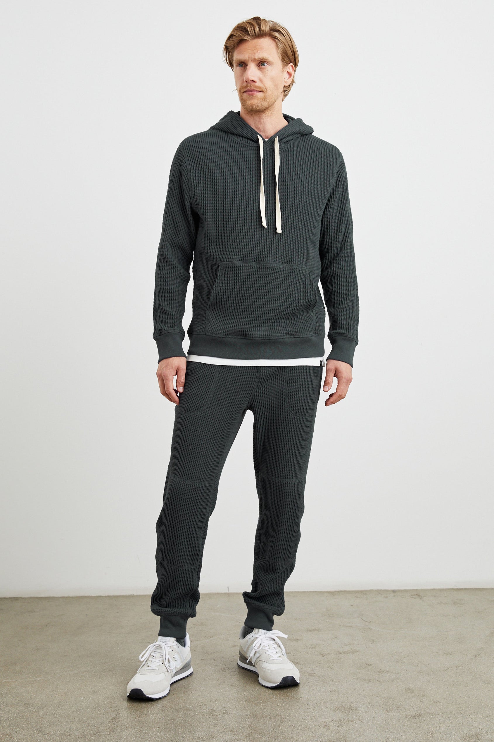 Preston Waffle Thermal Hoodie with a Kangaroo Pouch, Drawstring Hood and Elastic Cuffs in Ink Colorway - Front Full Body View Featured on Model