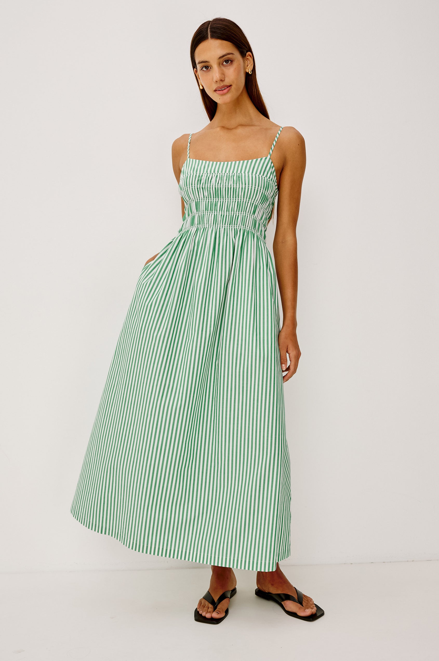Primrose Midi Dress in Cotton Poplin With Adjustable Spaghetti Straps, Smocked Empire Bodice, and Full Skirt in Emerald Stripe Colorway - Full Body Front View Featured on Model