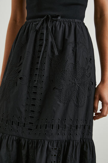 Prina Tiered Midi Skirt with a Drawstring Waist and Floral and Geometric Eyelet Details in Black Colorway - Front View Featured on Model