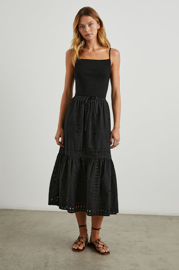 Prina Tiered Midi Skirt with a Drawstring Waist and Floral and Geometric Eyelet Details in Black Colorway - Front Full Body View Featured on Model