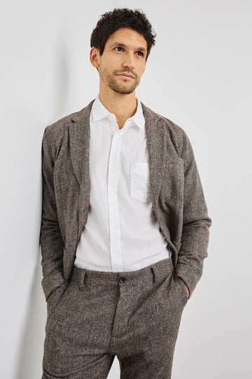 Reynard Blazer with Two Button Closure, Two Front Pockets, a Chest Welt Pocket, Herringbone Fabric in Highland Tweed Colorway, a Brown - Front View Featured on Model