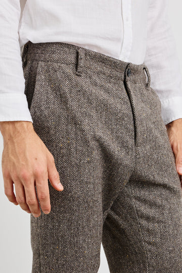 Reynard Blazer with Two Button Closure, Two Front Pockets, a Chest Welt Pocket, Herringbone Fabric in Highland Tweed Colorway, a Brown - Front View Featured on Model