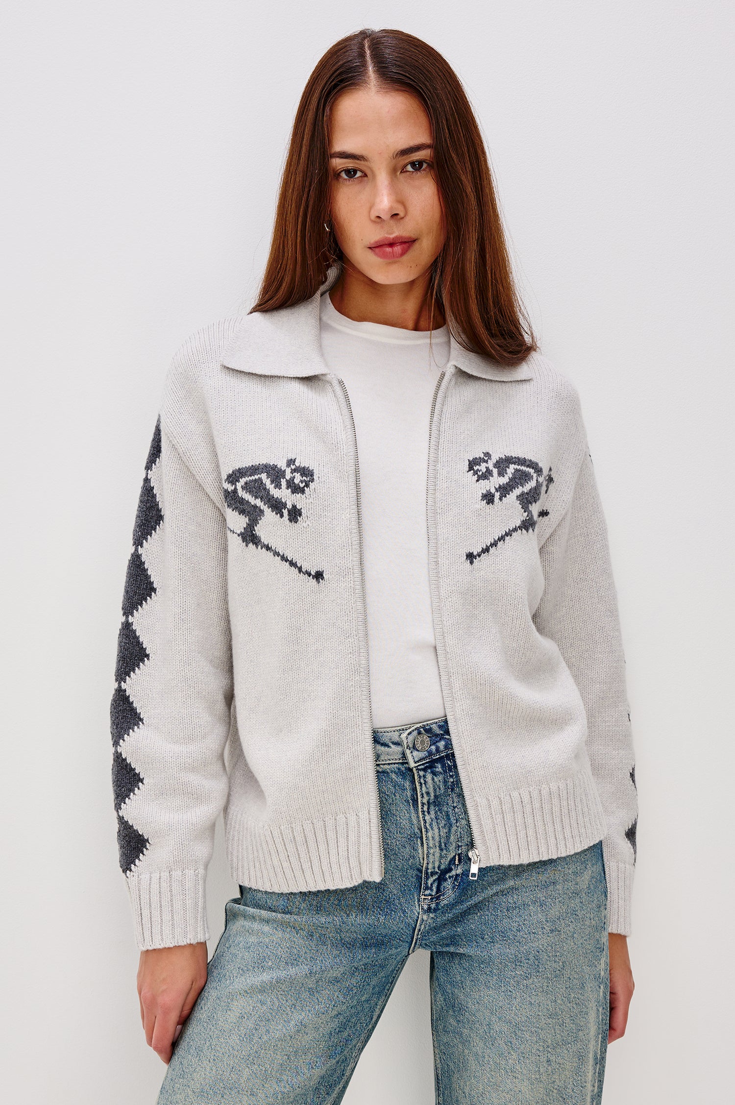 Rhea Longline Cardigan in Wool Blend With Skier Motifs, Stand Collar, Diamond Detailing at Long Sleeves, Relaxed Fit, and Front Zipper in Powder Grey Colorway - Upper Body View Featured on Model