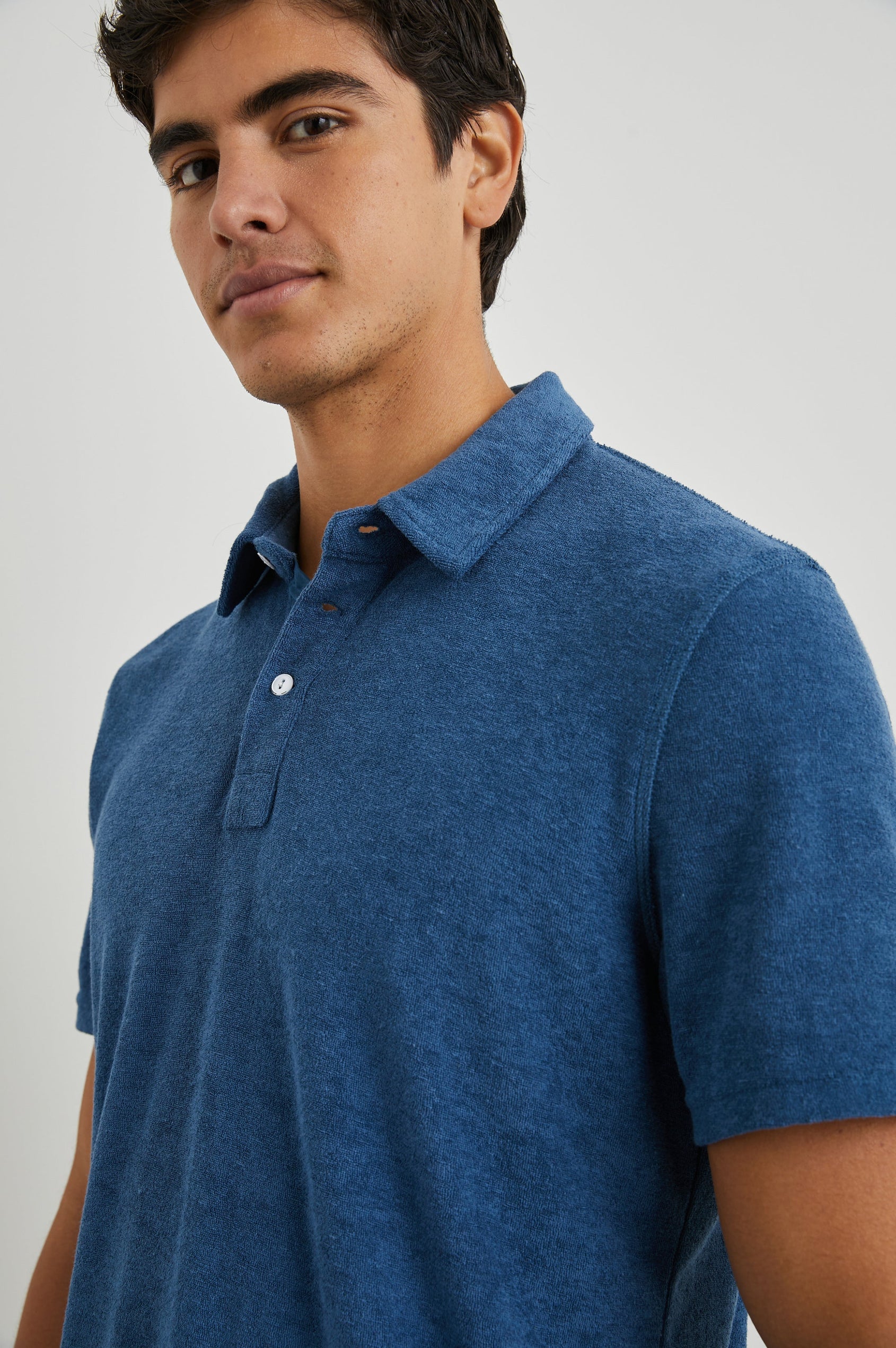 Rhen Short-Sleeve Polo Shirt with a Three-Button Placket in Ensign Blue Colorway - Front View Featured on Model