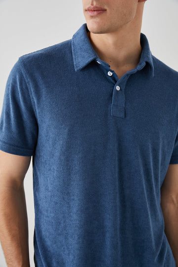 Rhen Short-Sleeve Polo Shirt with a Three-Button Placket in Ensign Blue Colorway - Front View Featured on Model