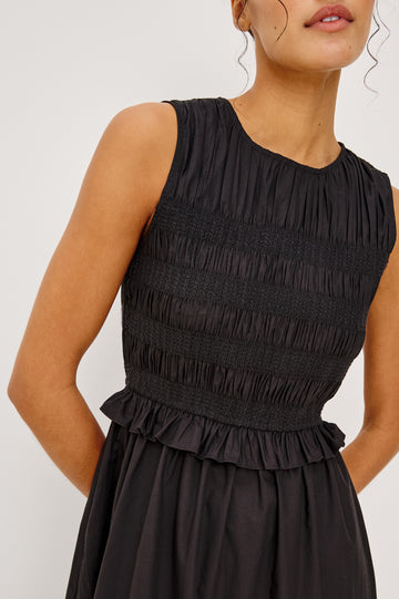 Rialto Midi Dress in Lightly Textured Poplin With Smocked Bodice, Ruffle Trim, Tiered Skirt, and Back Keyhole With Button-and-Loop Closure in Black Colorway - Upper Body Close Up View Featured on Model