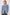 The Rodeo is button front collared denim jacket with side pockets and fringe along front yoke in Indigo Cowboy colorway, a medium blue wash. Front view featured on model.