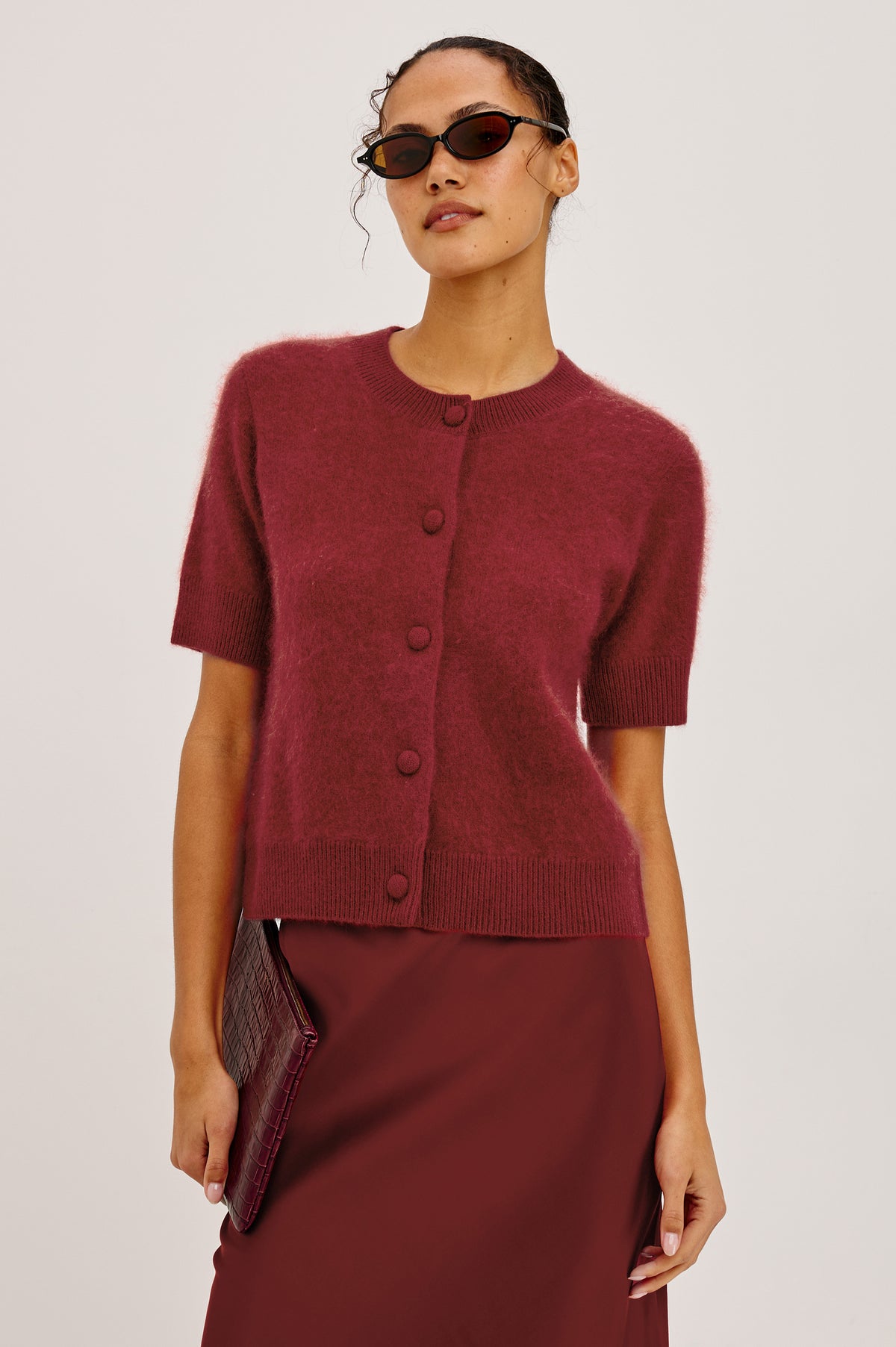 Roman Cardigan Sweater in Brushed Wool With Fluffy Feel With Slightly Cropped Fit, Crew Neck, Self-Covered Front Buttons, Short Sleeves, and Ribbed Trim in Crimson Colorway - Upper Body Front View Featured on Model