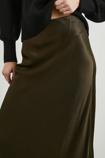 Romina Maxi Skirt in Dark Moss Colorway - Front View Featured on Model