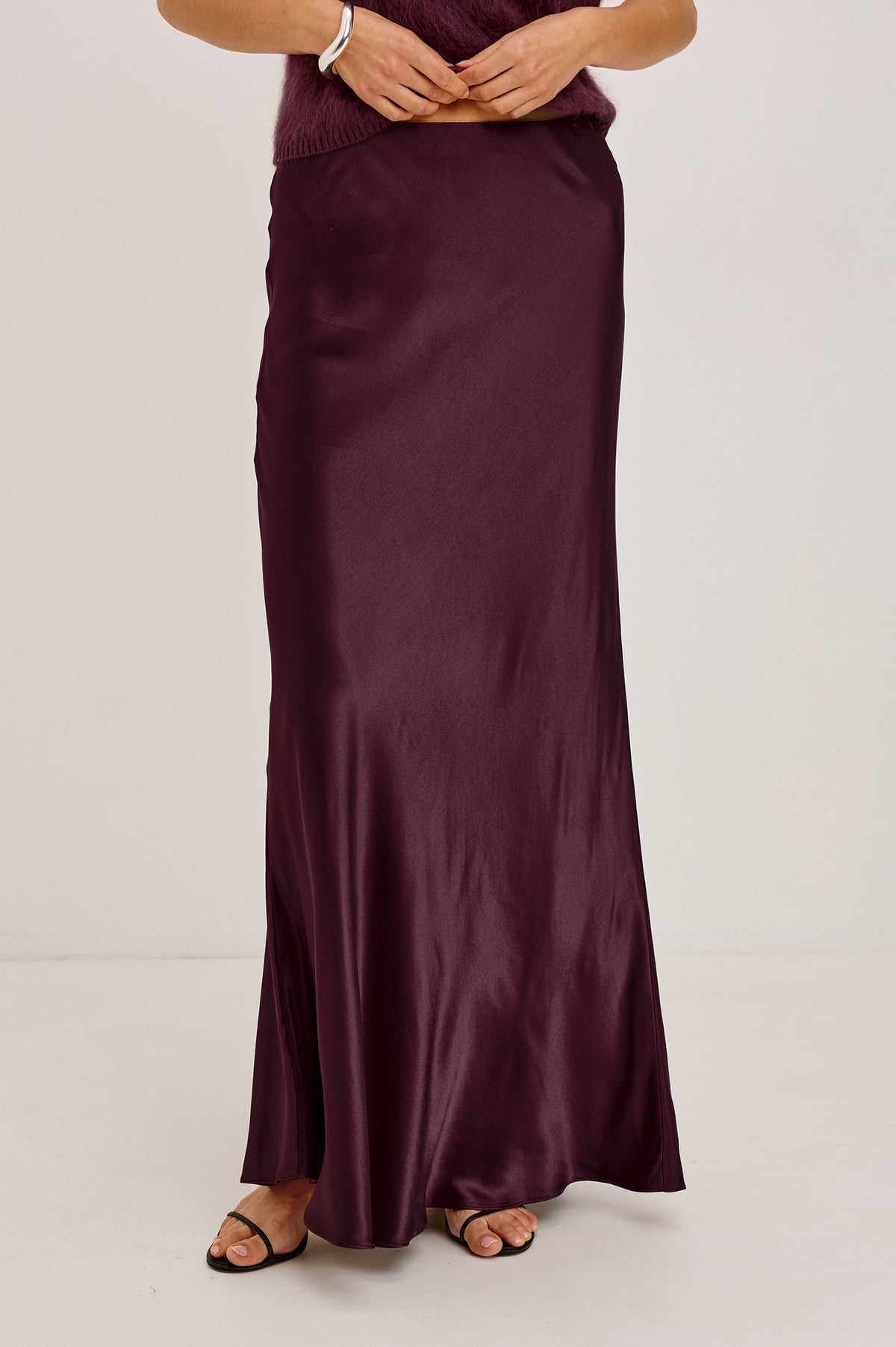 Romina Maxi Skirt Bias Cut in Satin-Back Crepe With Elastic High Waist in Wine Colorway - Full Body Front View Featured on Model.