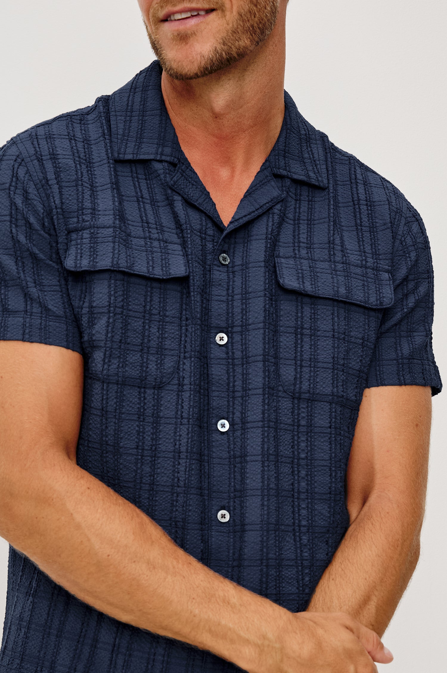 Rook Button-Up Shirt With Crosshatch Texture, Notched Collar, Short Sleeves, and Slightly Boxy Fit in Navy Colorway - Upper Body Close Up Front View Featured on Model