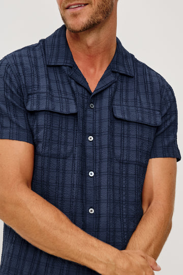 Rook Button-Up Shirt With Crosshatch Texture, Notched Collar, Short Sleeves, and Slightly Boxy Fit in Navy Colorway - Upper Body Close Up Front View Featured on Model