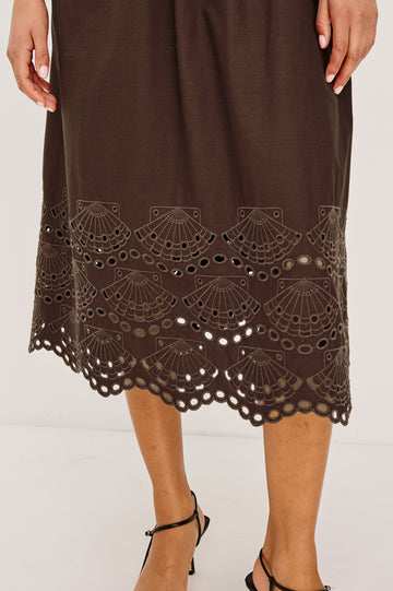 Roxanne Midi Dress in Cotton Poplin With Shirred Shoulders, Plunging V-Neck, Smocked Waist and Seashell Hem Embroidery in Espresso Colorway - Lower Body Close Up View Featured on Model