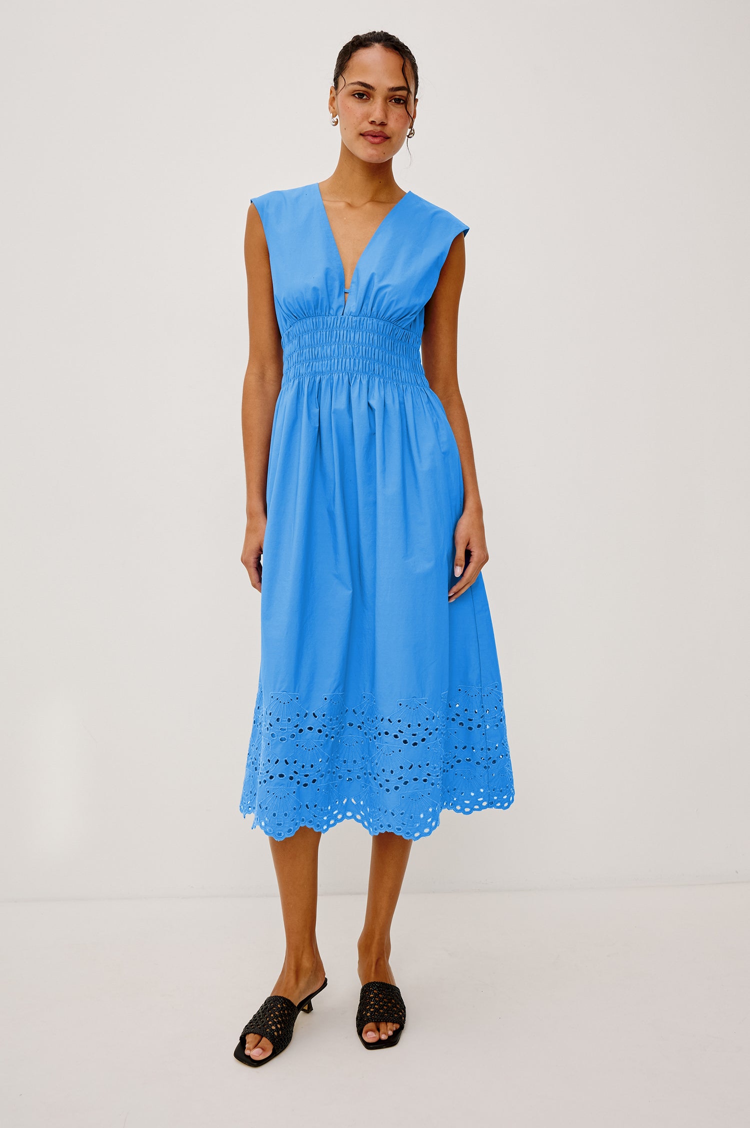 Roxanne Midi Dress in Cotton Poplin With Shirred Shoulders, Plunging V-Neck, Smocked Waist and Seashell Hem Embroidery in Harbor Blue Colorway - Full Body Front View Featured on Model