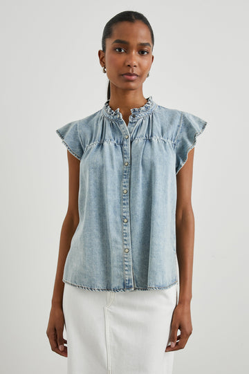 Ruthie Top with Flutter Cap Sleeves, a Ruffled Banded Collar, Buttons Down the Front, and Soft Shirring at Front Yoke in Faded Indigo Colorway - Front  View Featured on Model