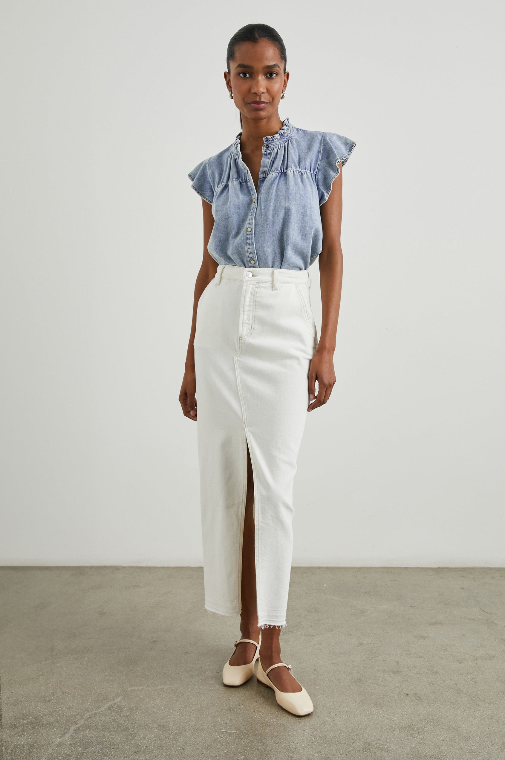 Ruthie Top with Flutter Cap Sleeves, a Ruffled Banded Collar, Buttons Down the Front, and Soft Shirring at Front Yoke in Faded Indigo Colorway - Front Full Body View Featured on Model